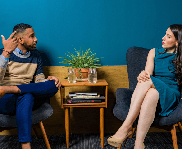 Man and Woman sitting, sharing thoughts while facing each other